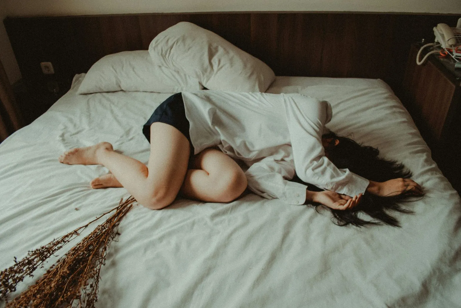 woman lying exhausted on a bed